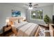 Inviting bedroom with a large window, ceiling fan, and neutral decor at 2021 Emerald Dr, Loganville, GA 30052