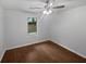 This bedroom features a ceiling fan, wood-look floors and a window at 2021 Emerald Dr, Loganville, GA 30052