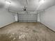 Empty two car garage with opener and sealed concrete floor at 2021 Emerald Dr, Loganville, GA 30052