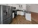 Modern kitchen with black appliances, sleek countertops, and stylish white cabinetry at 2021 Emerald Dr, Loganville, GA 30052