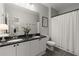 Bathroom featuring double sinks, a large mirror, and a shower-tub combination at 2400 Cumberland Se Pkwy # 804, Atlanta, GA 30339