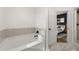 Bathroom features a bathtub, tile, and is located just off the primary bedroom at 2400 Cumberland Se Pkwy # 804, Atlanta, GA 30339