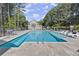 Community pool featuring clean water, sundeck, and outdoor seating in a wooded setting at 2400 Cumberland Se Pkwy # 804, Atlanta, GA 30339