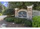 Elegant community sign with stone accents, shrubbery, and well-manicured landscaping at 2400 Cumberland Se Pkwy # 804, Atlanta, GA 30339
