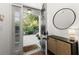 Inviting foyer with a stylish mirror, modern console table, and a glimpse of the outdoors at 2400 Cumberland Se Pkwy # 804, Atlanta, GA 30339