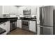 Bright kitchen featuring stainless steel appliances, white cabinets, and dark countertops at 2400 Cumberland Se Pkwy # 804, Atlanta, GA 30339