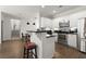 Modern kitchen with stainless steel appliances, white cabinets, and bar seating open to the dining and living area at 2400 Cumberland Se Pkwy # 804, Atlanta, GA 30339