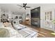 Bright living room with fireplace open to the kitchen with stainless steel appliances and bar seating at 2400 Cumberland Se Pkwy # 804, Atlanta, GA 30339