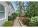 Charming backyard with a stone pathway surrounded by lush greenery and flowering bushes at 315 Stanyan Pl, Alpharetta, GA 30022