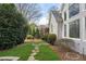 Beautiful backyard featuring well-maintained lawn and landscaping with stone walkway at 315 Stanyan Pl, Alpharetta, GA 30022