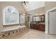 Bathroom with a large garden tub, glass shower, dual vanities, and tile floors at 315 Stanyan Pl, Alpharetta, GA 30022