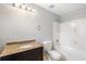 Bathroom featuring granite countertops, shower-tub combo, and a dark vanity at 315 Stanyan Pl, Alpharetta, GA 30022
