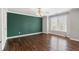 Large bedroom featuring hardwood floors, large windows, and a green accent wall at 315 Stanyan Pl, Alpharetta, GA 30022