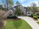 Stunning stone and stucco home with lush lawn, meticulously maintained landscaping, and a curved driveway at 315 Stanyan Pl, Alpharetta, GA 30022