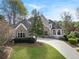 Attractive home with stone and stucco exterior, well-maintained lawn, and a long driveway at 315 Stanyan Pl, Alpharetta, GA 30022