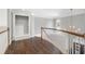 Bright hallway with hardwood floors, white trim, and decorative lighting fixture at 315 Stanyan Pl, Alpharetta, GA 30022