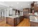Gourmet kitchen with a large island, custom cabinets, stainless steel appliances, and hardwood floors at 315 Stanyan Pl, Alpharetta, GA 30022