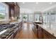 Bright kitchen with a stainless steel stove, custom cabinets, and a view of the breakfast nook at 315 Stanyan Pl, Alpharetta, GA 30022