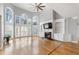 Bright living room featuring a fireplace, custom built-ins, hardwood floors and large arched windows at 315 Stanyan Pl, Alpharetta, GA 30022