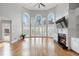 Open living room boasts hardwood floors, large windows, and a cozy fireplace with custom cabinetry at 315 Stanyan Pl, Alpharetta, GA 30022