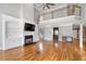 Beautiful living room featuring a fireplace with built-ins, a wet bar, and hardwood floors at 315 Stanyan Pl, Alpharetta, GA 30022