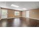 Spacious living room features gleaming hardwood floors, a window, and a door to the outside at 315 Stanyan Pl, Alpharetta, GA 30022