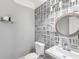 Stylish powder room with unique wallpaper, modern fixtures, and a sleek vanity at 315 Stanyan Pl, Alpharetta, GA 30022