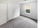 Bright bedroom featuring a large window and neutral carpet at 4661 Cedar Park Trl, Stone Mountain, GA 30083
