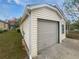 Attached one car garage featuring siding to match the house, and a concrete driveway at 4661 Cedar Park Trl, Stone Mountain, GA 30083