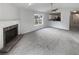 Open living room with a fireplace and view into kitchen at 4661 Cedar Park Trl, Stone Mountain, GA 30083