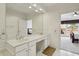 Bright bathroom with double vanity, tile flooring, and a doorway into the bedroom at 132 Westchester Se Dr, Smyrna, GA 30082