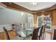 Bright dining area with a glass table, six chairs, and large windows overlooking the yard at 132 Westchester Se Dr, Smyrna, GA 30082