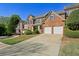 Attractive brick townhouse with a two-car garage and well-maintained front yard, offering suburban charm at 132 Westchester Se Dr, Smyrna, GA 30082