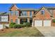 Charming brick home featuring a well-manicured lawn and a two-car garage, perfect for Gathering living at 132 Westchester Se Dr, Smyrna, GA 30082