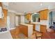 Charming kitchen with island, hardwood floors, white countertops and arched doorway at 132 Westchester Se Dr, Smyrna, GA 30082