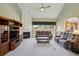 Cozy living room with a fireplace, built-in entertainment center, and view to the backyard through large windows at 132 Westchester Se Dr, Smyrna, GA 30082