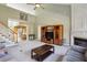 Spacious living room featuring a fireplace, large entertainment center, and stairs leading to the upper level at 132 Westchester Se Dr, Smyrna, GA 30082