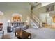 Comfortable living room with plush seating, a cozy fireplace, and a view into the adjacent kitchen area at 132 Westchester Se Dr, Smyrna, GA 30082