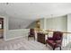 Cozy loft area with plush carpet, a decorative chest, and natural light at 132 Westchester Se Dr, Smyrna, GA 30082