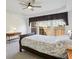 Comfortable main bedroom with tray ceilings, ceiling fan, and a view of the backyard at 132 Westchester Se Dr, Smyrna, GA 30082