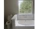 Bathroom featuring a soaking tub and large window, offering a relaxing space to enjoy at 4423 Roche St, Atlanta, GA 30349
