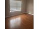 Bedroom with wood floors and window, offering a comfortable and well-lit space to enjoy at 4423 Roche St, Atlanta, GA 30349