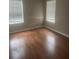 Bedroom with wood floors and windows, offering a comfortable and well-lit space to relax at 4423 Roche St, Atlanta, GA 30349