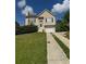 Charming two-story home featuring a well-manicured lawn and a classic suburban aesthetic at 4423 Roche St, Atlanta, GA 30349