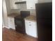 Modern kitchen with white cabinets, black appliances, and tile countertops at 4423 Roche St, Atlanta, GA 30349