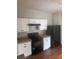 Functional kitchen with white cabinets, a black refrigerator, and range at 4423 Roche St, Atlanta, GA 30349