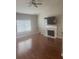 Cozy living room featuring a fireplace with marble surround and hardwood flooring at 4423 Roche St, Atlanta, GA 30349