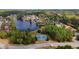 Aerial view of neighborhood and lake with tennis courts in a wooded area at 7200 Brigidoon Rose, Douglasville, GA 30134