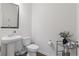 A modern powder room with a pedestal sink and tasteful decor, perfect for guests at 7200 Brigidoon Rose, Douglasville, GA 30134