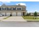 Charming townhome featuring a brick facade, individual garages, and well-maintained landscaping at 7200 Brigidoon Rose, Douglasville, GA 30134
